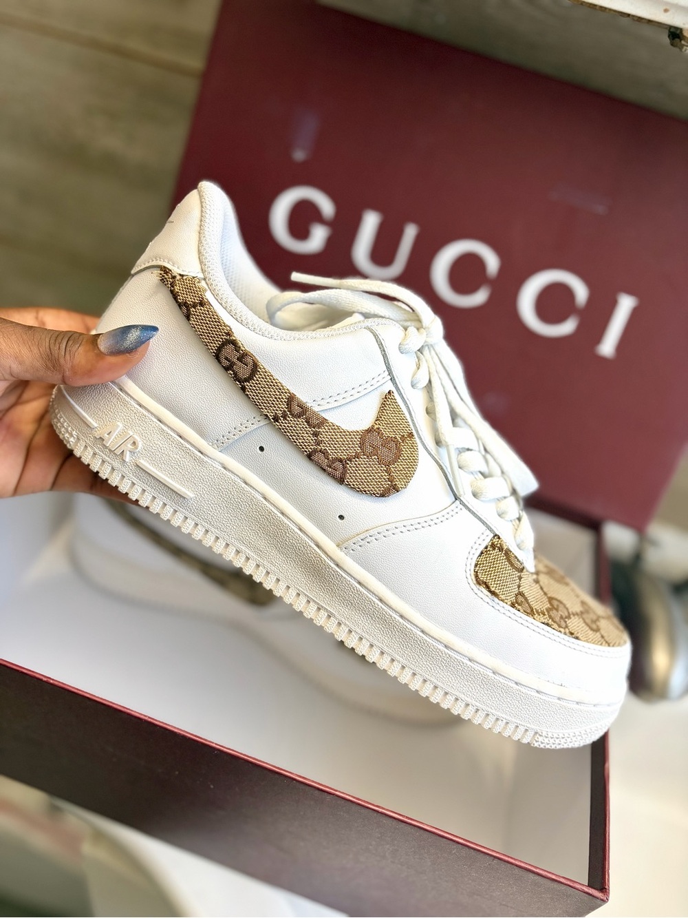 Nike Air Force 1 sneakers featuring reworked Gucci monogram canvas panels